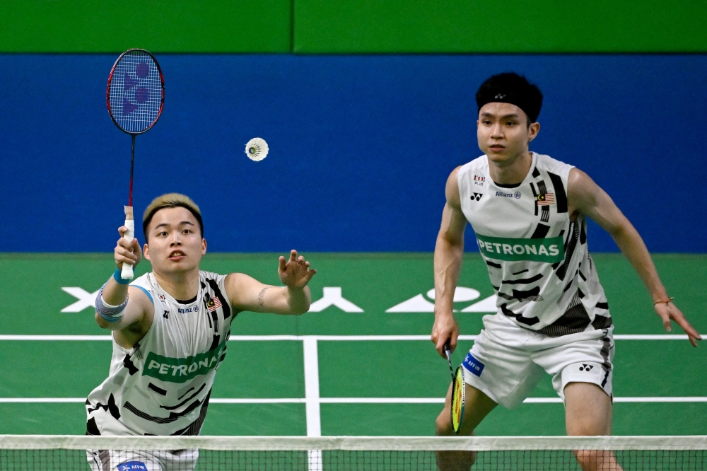 Aaron Chia (left) and Soh Wooi Yik compete during the India Open 2025 badminton tournament in New Delhi on January 18, 2025. — AFP pic