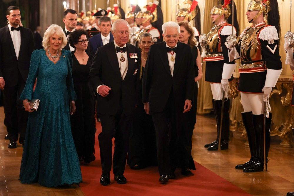 Italy's President Sergio Mattarella (right) walks along with Britain's King Charles III and Queen Camilla at the Quirinale Presidential Palace before a state banquet in Rome on April 9, 2025. — AFP pic