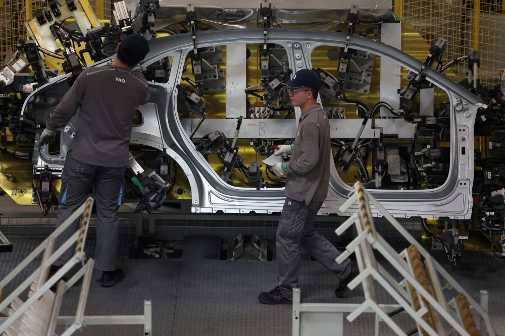 Employees work on the production line at a factory of Chinese electric vehicle (EV) maker Nio in Hefei, Anhui province, China April 2, 2025. — Reuters pic