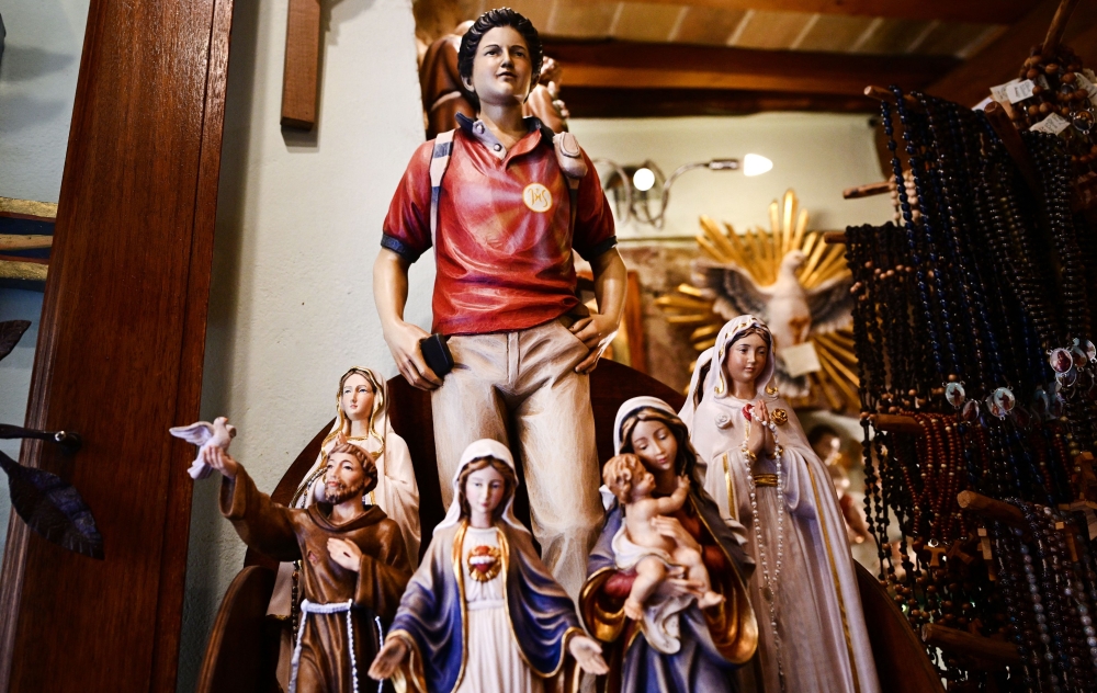 Figurines of Blessed Carlo Acutis, dubbed “God’s Influencer”, are on sale in a souvenirs shop in Assisi where Acutis is on display, on April 3, 2025.  — AFP pic