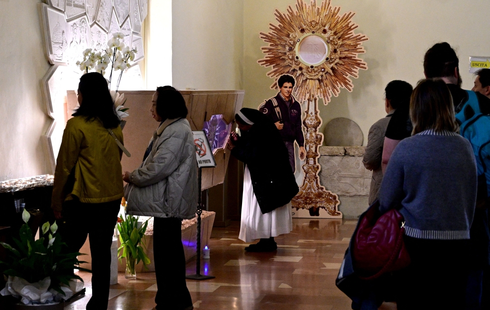 Faithful visit the tomb of Blessed Carlo Acutis, in the Shrine of the Renunciation in Assisi, part of the Church of Saint Mary Major, on April 3, 2025. — AFP pic