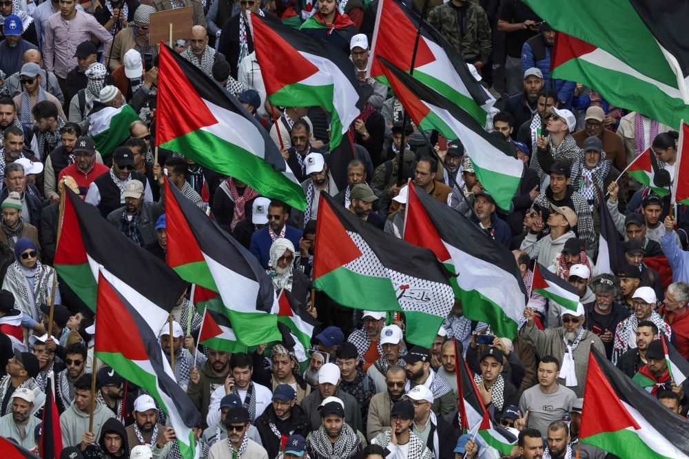 People lift flags of Palestine during a national march in support of Palestinians in the capital Rabat April 6, 2025. — AFP pic