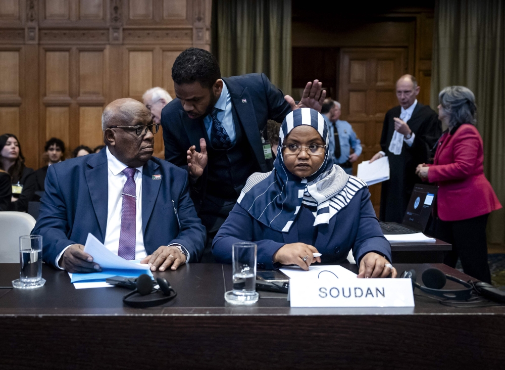 Muawia Osman Mohamed Khair (L), Sudan's acting Minister of Justice, and Sudanese ambassador to the Netherlands Omaima Alsharief wait for the start of a hearing before the International Court of Justice in The Hague today — AFP pic.
