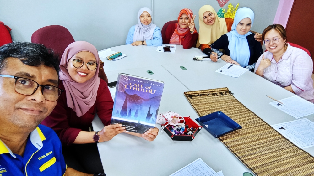 Khairul, Farahhein and Syafawati, along with other educators, after a demonstration on using TTRPGs in language learning. — Picture courtesy of Khairul Hisham