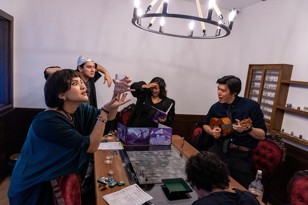 Kirthana (centre) at Here Be Dragons Board Game Store, playing a Halloween-themed D&D game. — Picture courtesy of Here Be Dragons