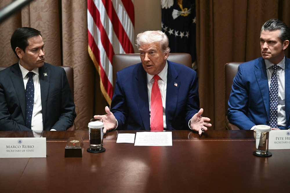 US President Donald Trump, alongside Secretary of State Marco Rubio and Secretary of Defence Pete Hegseth, speaks during a Cabinet meeting in the Cabinet Room of the White House in Washington April 10, 2025. — AFP pic