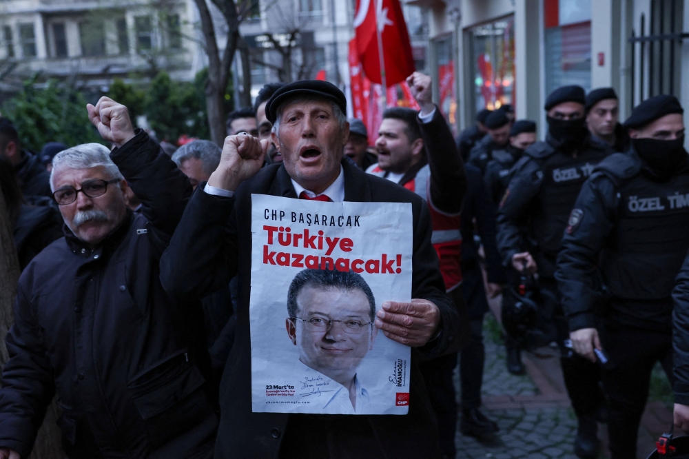 A man holds a poster with a picture of Istanbul Mayor Ekrem Imamoglu during a rally to protest against the arrest of Imamoglu as part of a corruption investigation, in Istanbul April 9, 2025. — Reuters pic