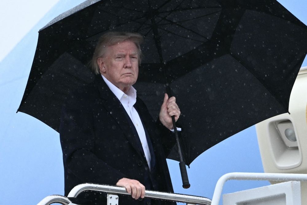 US President Donald Trump boards Air Force One before departing from Joint Base Andrews in Maryland yesterday. Trump is heading to Palm Beach, where he is spending the weekend at his Mar-a-Lago resort. — AFP pic