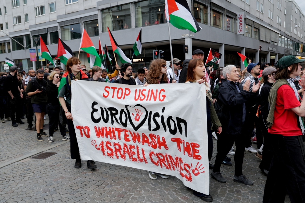 Demonstrators carry a banner and Palestinian flags during a protest against Israeli participation in the Eurovision Song Contest, ahead of the second semi-final, in Malmo Sweden, May 9, 2024.  — Reuters pic