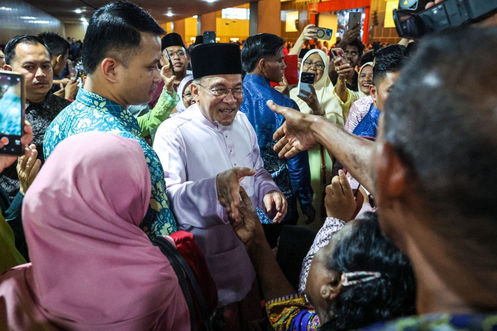 Prime Minister Datuk Seri Anwar Ibrahim interacts with members of the public during the Madani Aidilfitri Celebration at the PICCA @Arena Convention Centre in Butterworth April 12, 2025. — Bernama pic