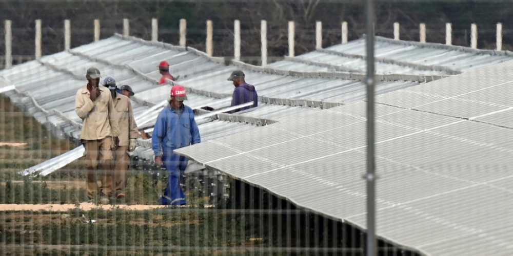 Employees work on the assembly of the La Yuca photovoltaic solar park in Cienfuegos Province, Cuba. — AFP pic
