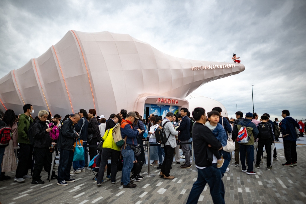 People queue to enter the Pasona Natureverse pavilion on the first day of the six-month 2025 Osaka Expo in the city of Osaka on April 13, 2025. — AFP pic
