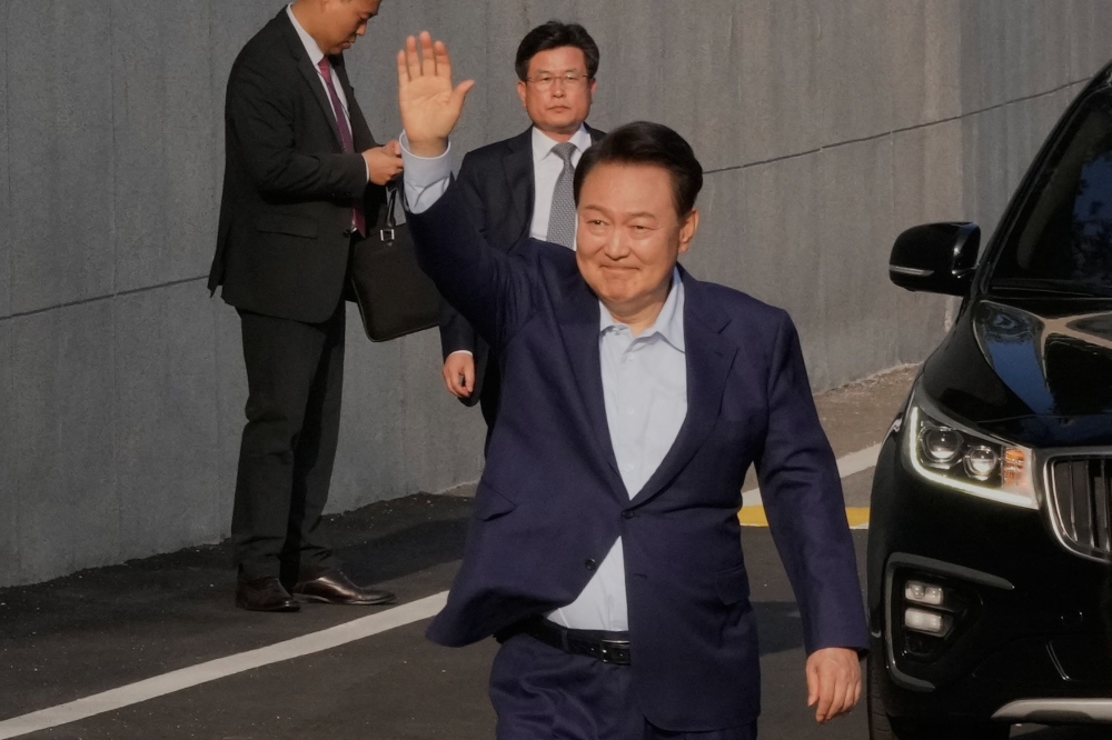 Ousted South Korean president Yoon Suk Yeol waves before leaving the presidential residence in Seoul on April 11. — AFP pic