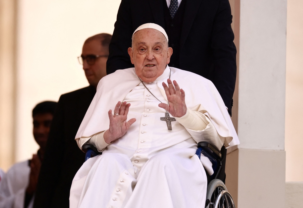 Pope Francis waves as he unexpectedly appears during the Palm Sunday Mass in Saint Peter's Square at the Vatican, April 13, 2025. — Reuters pic