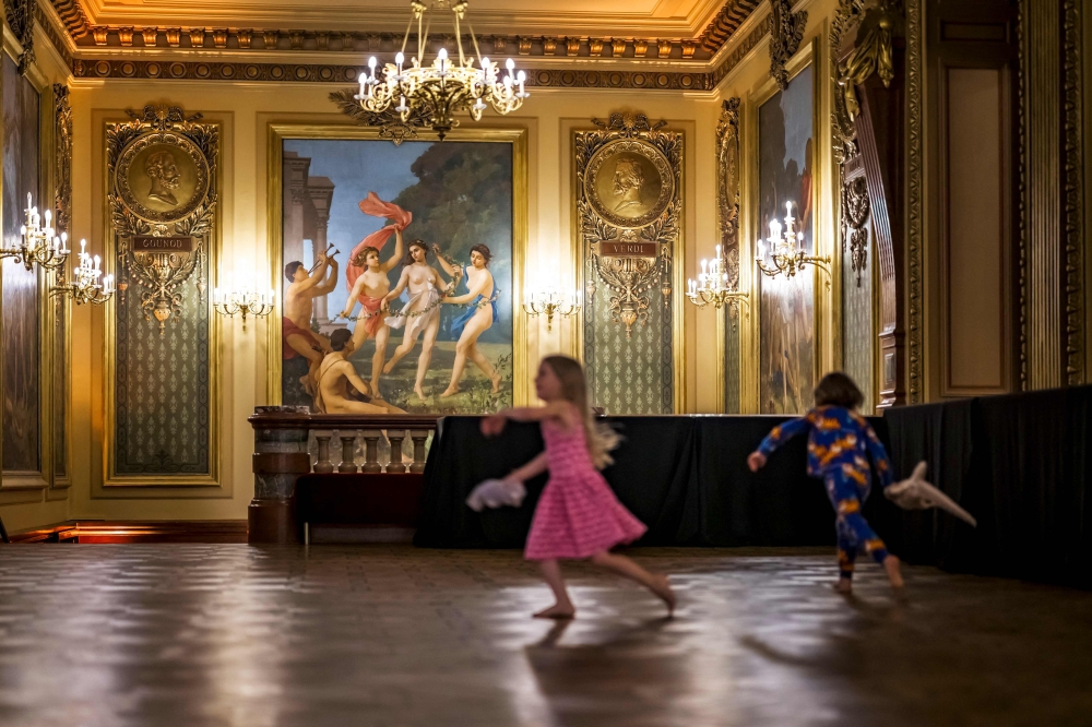 Children are playing in the fresco-covered foyer of the Grand Theatre de Geneve, during an opera sleepover event in Geneva on April 5, 2025. — AFP pic