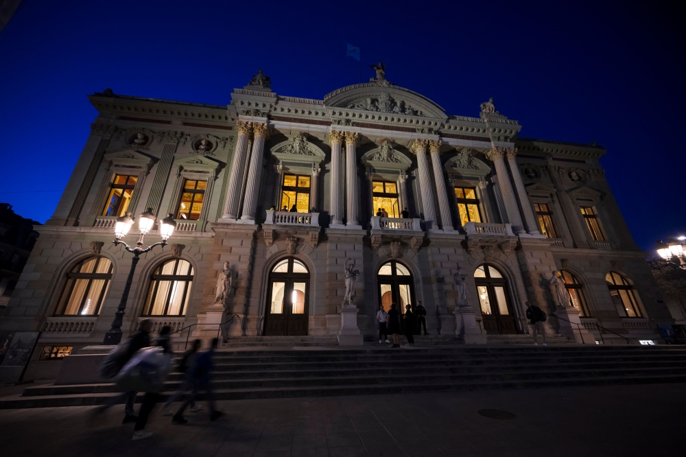 People arrive at the Grand Theatre for an opera sleepover event in Geneva on April 5, 2025. — AFP pic