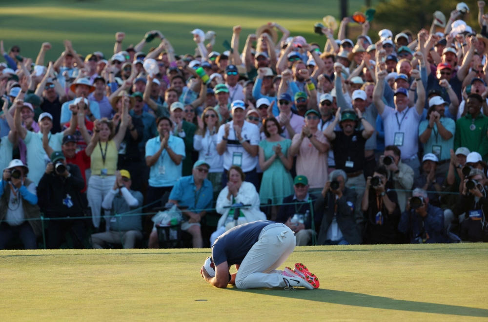 Northern Ireland’s Rory McIlroy celebrates on the 18th green of the 1st play-off hole after winning The Masters and completing a career grand slam at the Augusta National Golf Club, Augusta, Georgia, April 13, 2025. — Reuters pic 
