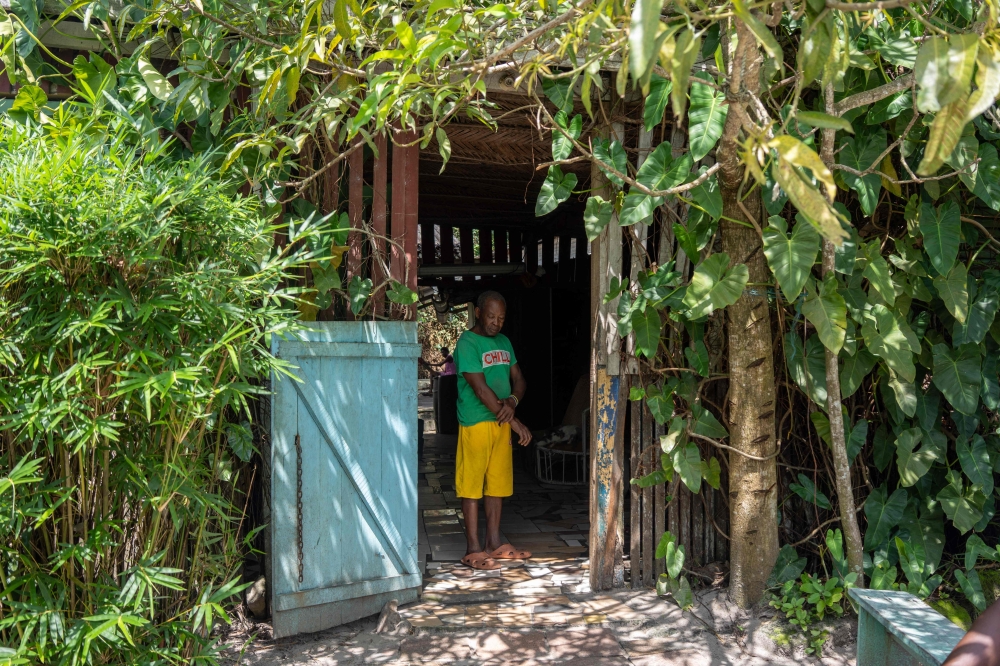 Mr. Kouassi, the owner of a local bar, stands inside the bar in the fishing village of Otangani on April 6, 2025. — AFP pic