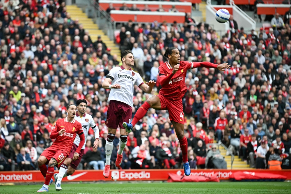 Liverpool’s Dutch defender #04 Virgil van Dijk and West Ham United’s Greek defender #15 Konstantinos Mavropanos jump to head the ball during the English Premier League football match between Liverpool and West Ham United at Anfield in Liverpool, April 13, 2025. — AFP pic 