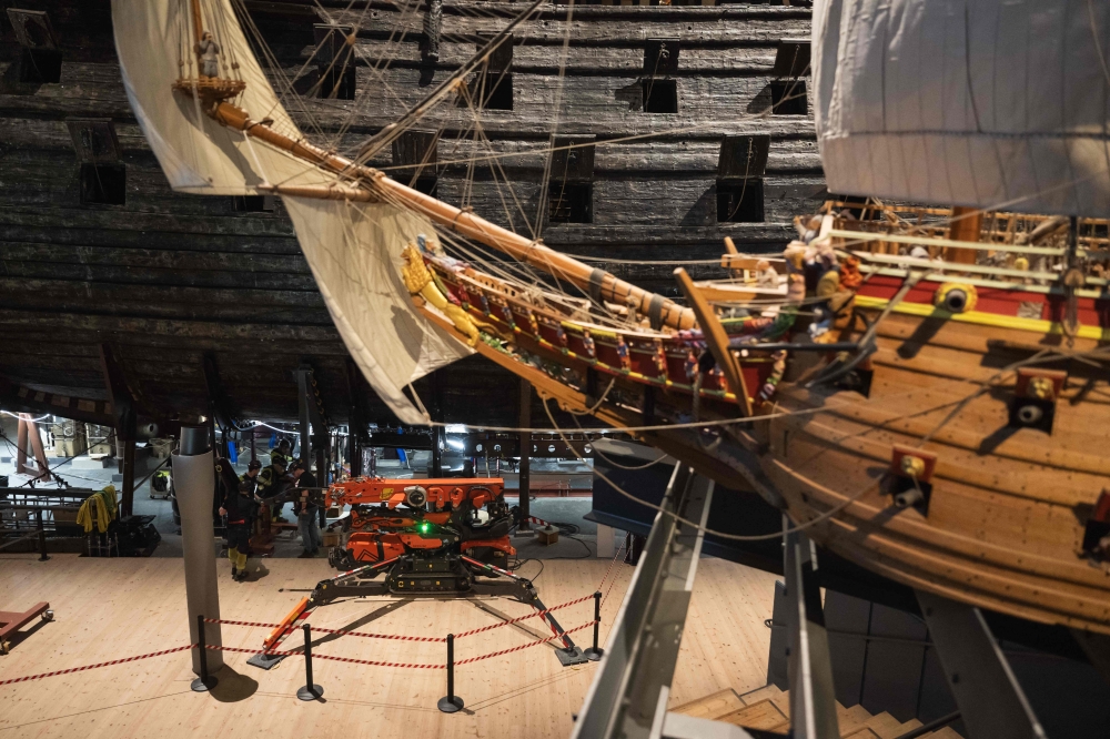 Workers install a new metallic support structure for the 17th-century warship Vasa at the Vasa Museum in Stockholm April 8, 2025. The new structure will replace the current one, which has been damaging the ship over time. — AFP pic