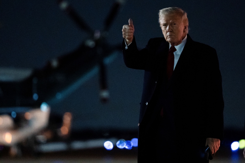 US President Donald Trump gestures as he arrives at Joint Base Andrews in Maryland, April 13, 2025. — Reuters pic 