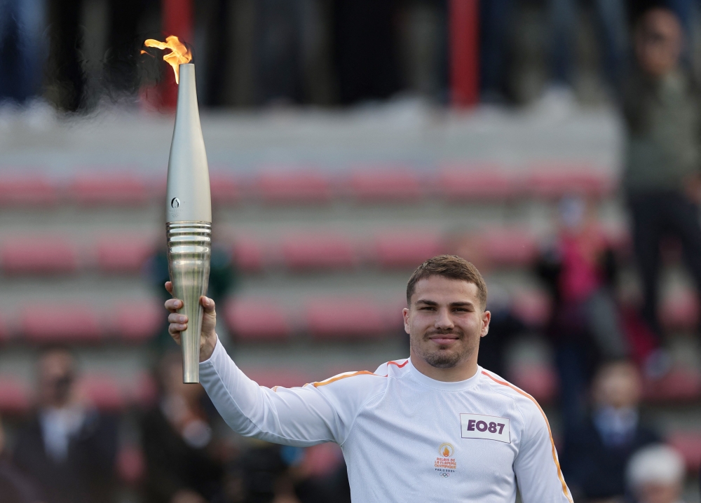 French rugby player Antoine Dupont holds the Olympic torch as part of the Olympic and Paralympic Torch Relays in the Ernest Wallon stadium in Toulouse, south-western France, on May 17, 2024, ahead of the Paris 2024 Olympic Games. — AFP pic