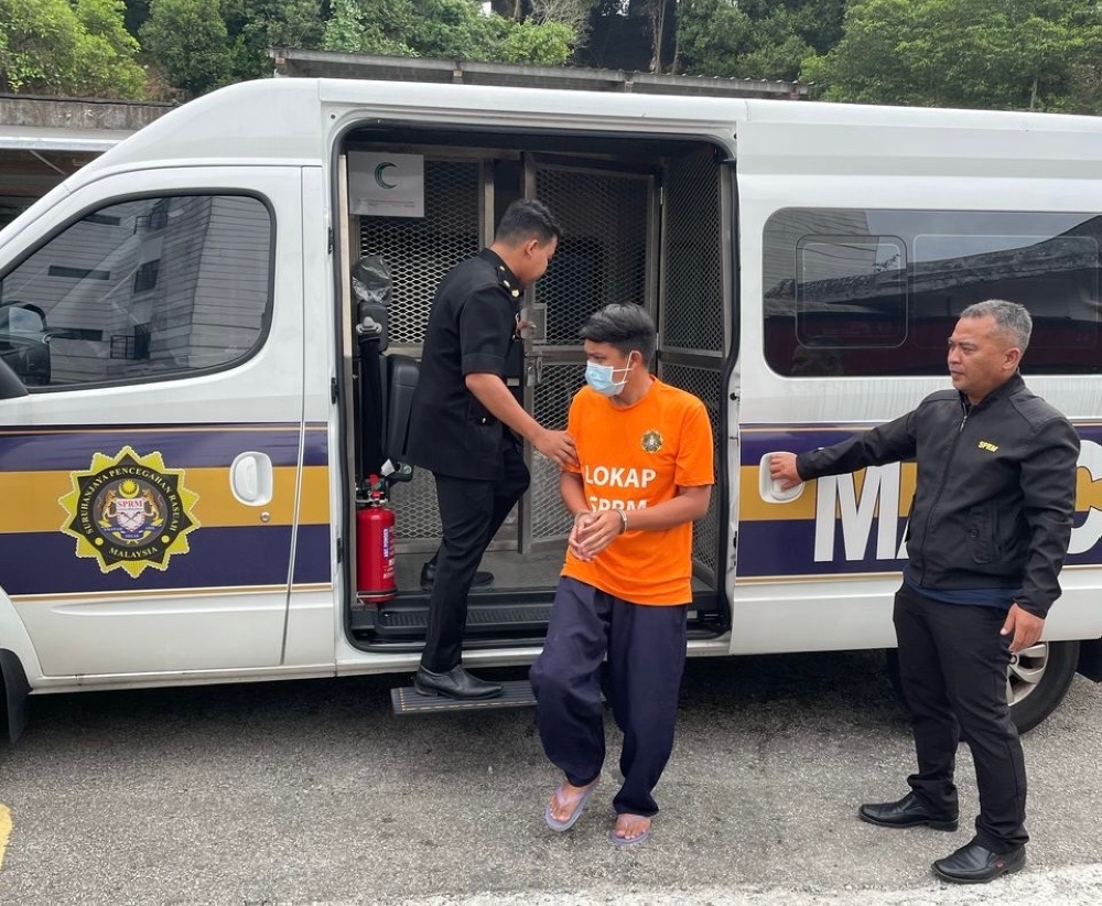 A 34-year-old manager seen escorted by Malaysian Anti-Corruption Commission (MACC) officers to the Johor Baru Magistrate's Court today for a remand order application April 15. — Picture courtesy of the Johor Malaysian Anti-Corruption Commission (MACC) 