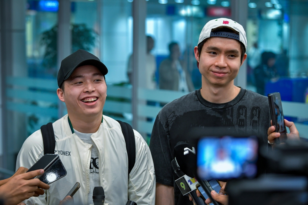 National men’s doubles pair Aaron Chia and Soh Wooi Yik speak to members of the media at Kuala Lumpur International Airport Terminal 1 in Sepang April 14, 2025. — Bernama pic