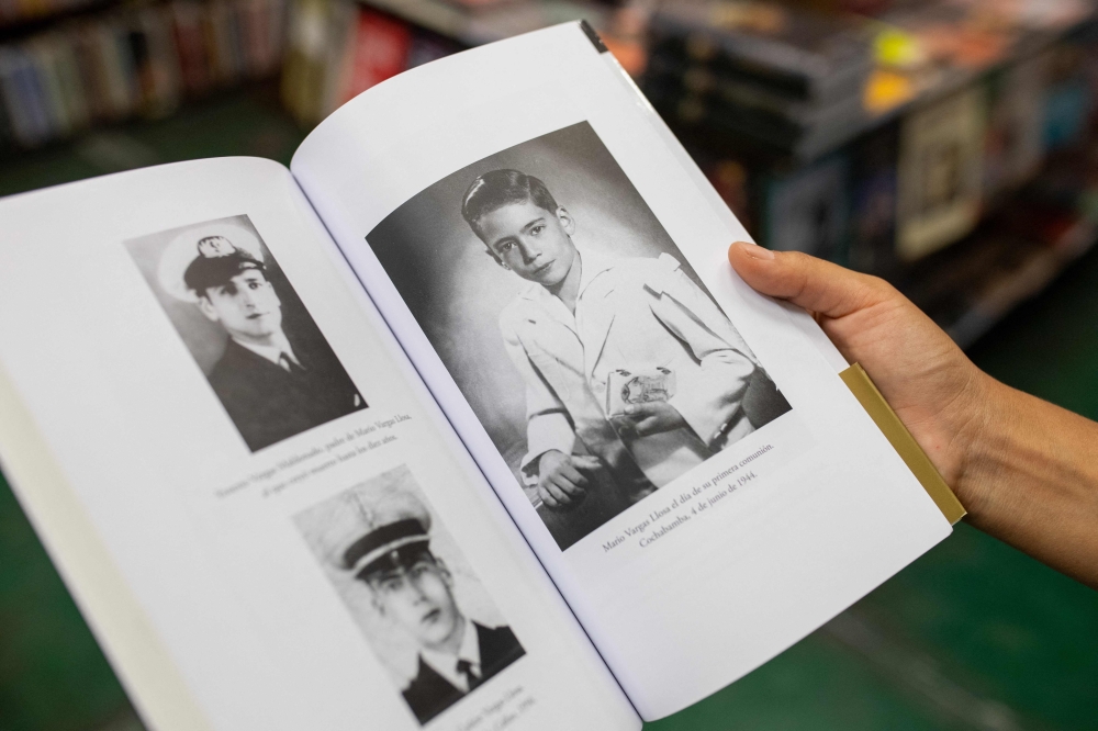Portraits of late writer Mario Vargas Llosa are seen on the book ‘Palabras en el mundo’ (Words in the World), by Alonso Cueto, at El Virrey bookstore in Miraflores, Lima April 14, 2025. — AFP pic
