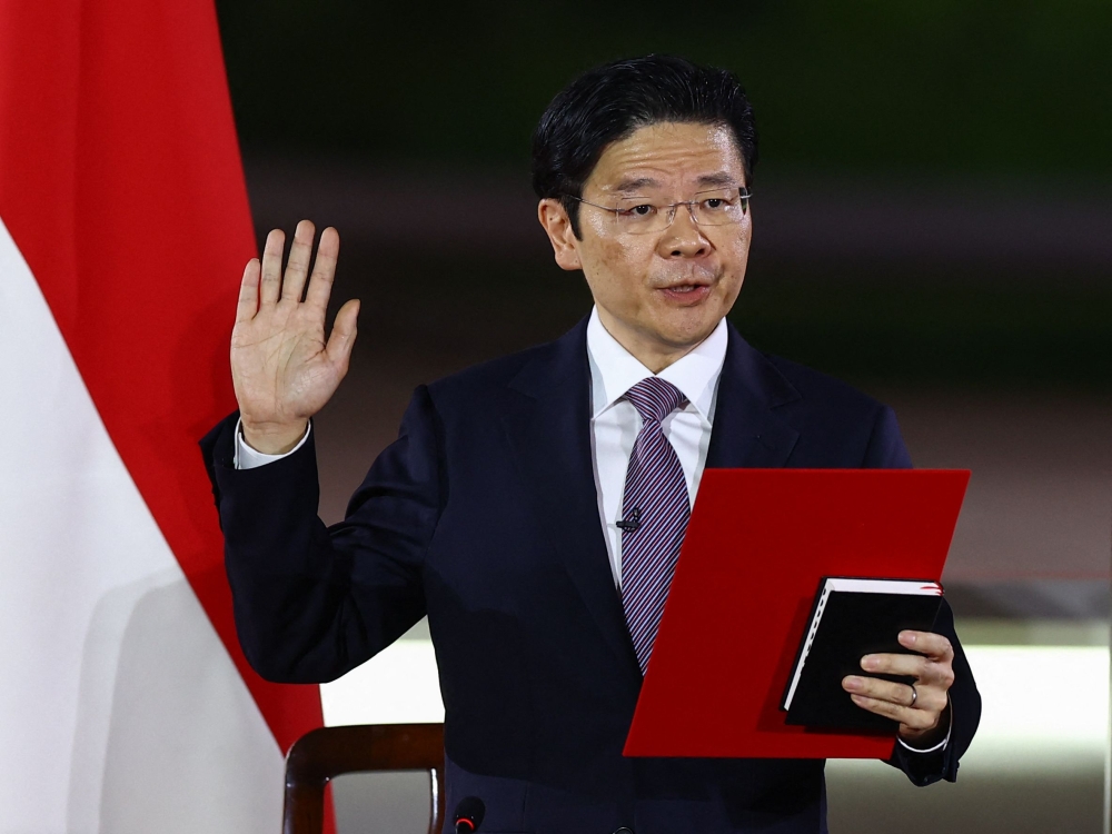 File picture of Singapore’s new Prime Minister Lawrence Wong being sworn in during a ceremony at the Istana in Singapore on May 15, 2024. Wong has called a general election on May 3, 2025, citing profound global shifts and growing instability as reasons for Singaporeans to choose a team to steer the country through uncertain times. — AFP pic