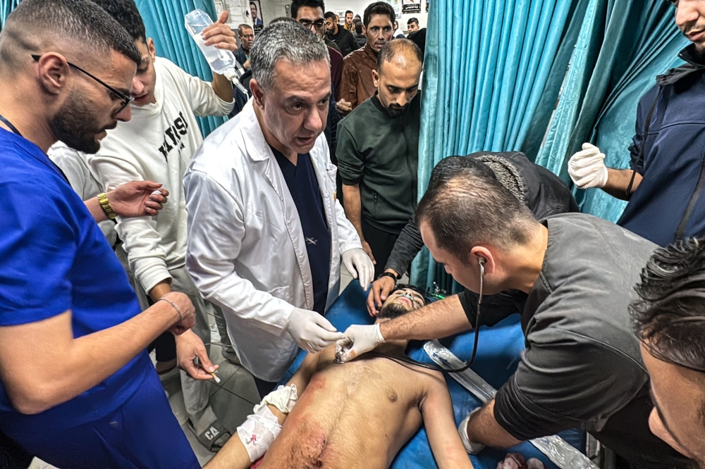 Hussam Abu Safiya (centre), the director of the Kamal Adwan Hospital, supervises the treatment of a Palestinian man, injured in an Israeli strike on Beit Lahia in the northern Gaza Strip in this file picture dated November 21, 2024. Abu Safiya, a 52-year-old paediatrician, who was detained by Israeli forces in December is being held in ‘inhumane’ conditions by Israel and subjected to ‘physical and psychological intimidation’, his lawyer told AFP in April 2025. — AFP pic 