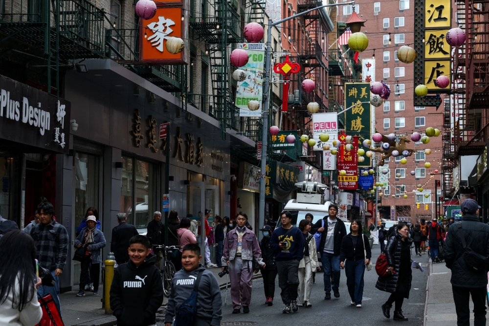People walk through Chinatown in New York City, April 14, 2025. China warned Wednesday it was ‘not afraid’ to fight a trade war with the United States and reiterated calls for dialogue, after US President Donald Trump said it was up to Beijing to come to the negotiating table. — Reuters pic 