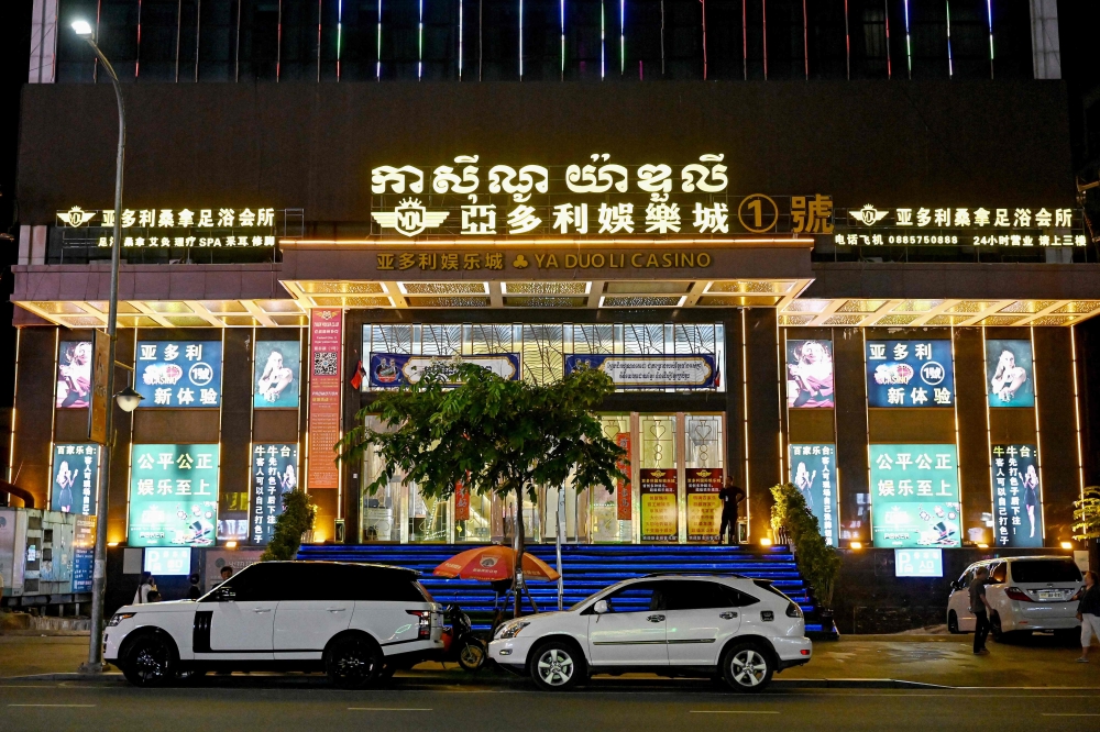 This photo, taken on April 8, shows vehicles parked in front of a casino in Sihanoukville. — AFP pic