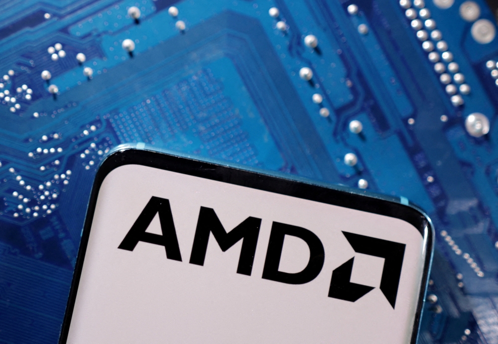 A smartphone with a displayed AMD logo is placed on a computer motherboard in this illustration taken March 6, 2023. — Reuters pic
