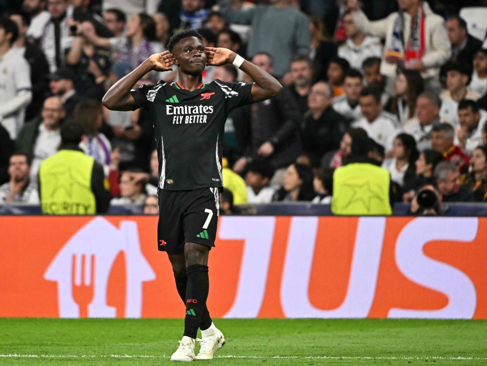 Arsenal's English midfielder Bukayo Saka celebrates scoring his team's first goal during the UEFA Champions League quarter final second leg football match with Real Madrid CF at Santiago Bernabeu Stadium in Madrid on April 16, 2025. — AFP pic