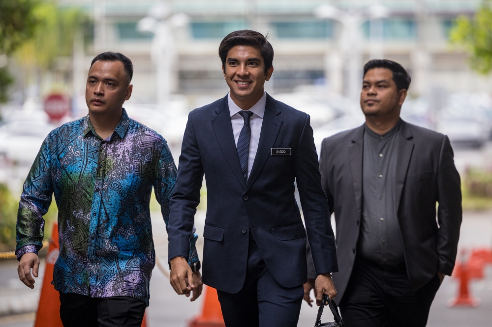 Muar MP Syed Saddiq Syed Abdul Rahman (centre) arrives at the Palace of Justice for the third day of his appeal against convictions related to criminal breach of trust, misappropriation, and money laundering involving Armada funds. — Bernama pic