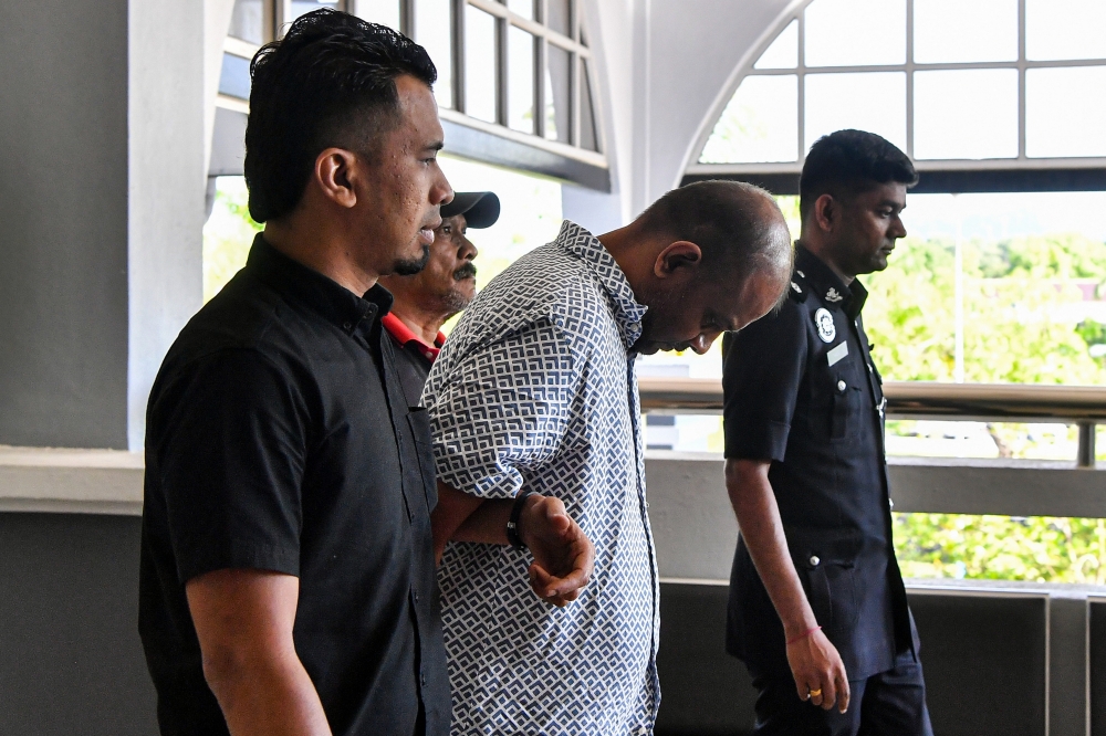 R. Suresh Khanna, 47, was charged with voluntarily causing grievous hurt with a dangerous weapon to B. Nagarajah, 40, at a telecommunications shop in a shopping centre in Seremban at about 8.10pm last Monday (April 14). — Bernama pic 