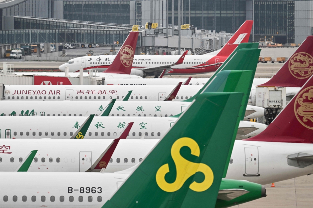 A Boeing 737-89P of Shanghai Airlines taxis next to Airbus aircrafts at the Shanghai Pudong International Airport in Shanghai on April 17, 2025. — AFP pic