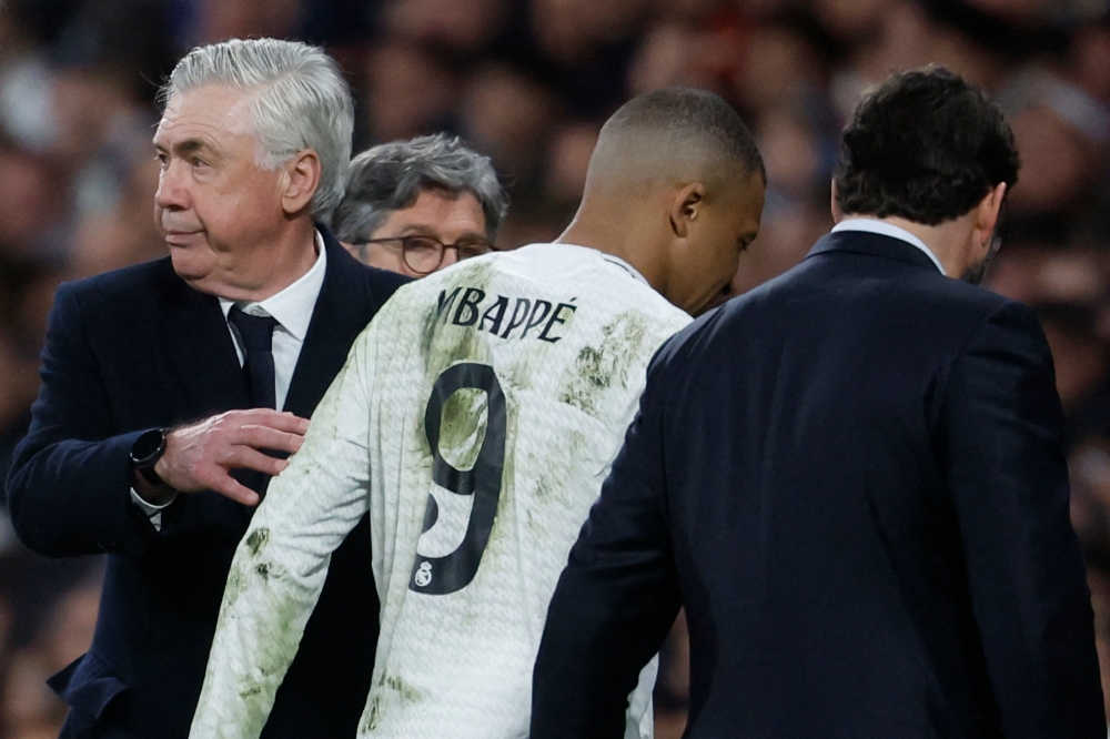 Real Madrid's French forward Kylian Mbappe leaves the pitch after resulting injured during the UEFA Champions League quarter final second leg football match between Real Madrid CF and Arsenal at Santiago Bernabeu Stadium in Madrid on April 16, 2025. — AFP pic