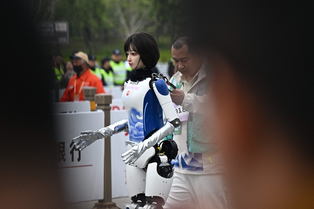 A humanoid robot takes part in the world’s first half marathon against humans in Beijing, China on April 19, 2025. — AFP pic