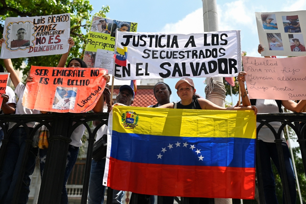 Family members of Venezuelan migrants, whom the US alleged to be members of the Tren de Aragua gang and sent to the Terrorism Confinement Center (CECOT) prison in El Salvador, hold signs and pictures of their loved ones during a protest in Caracas, Venezuela April 15, 2025. — Reuters pic