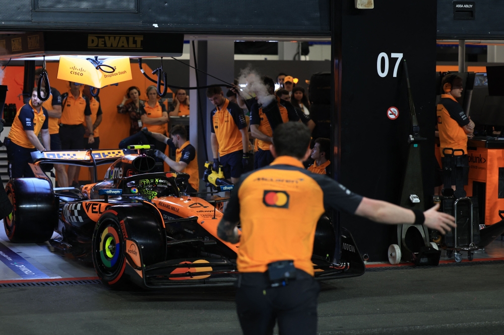 McLaren's British driver Lando Norris is ushered out of the garage during the qualifying round for the 2025 Saudi Arabia Formula One Grand Prix at the Jeddah Corniche Circuit on April 19, 2025. — AFP pic