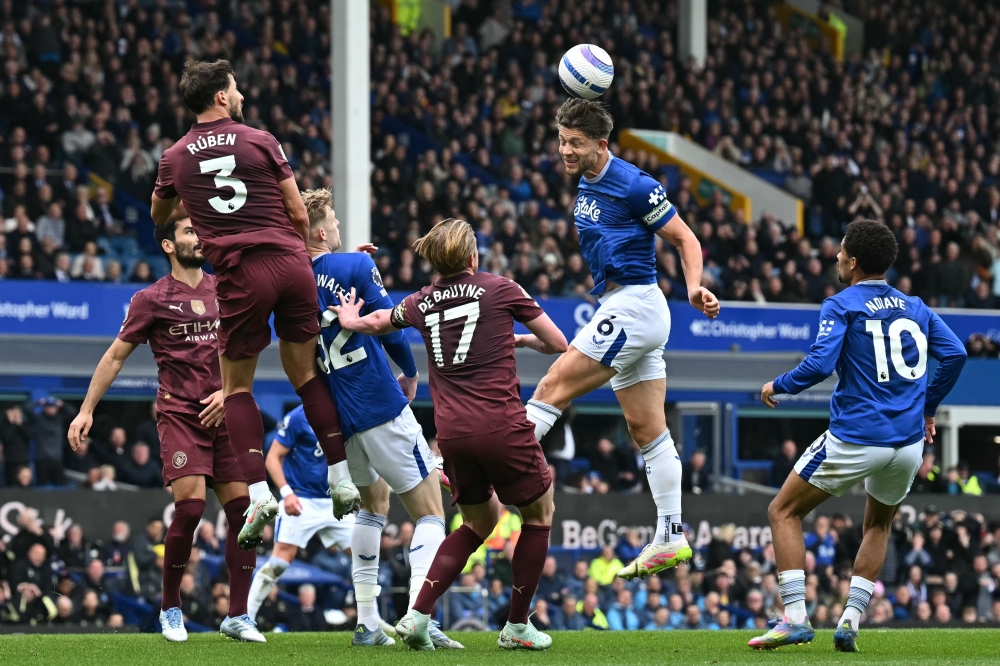 Everton's English defender James Tarkowski wins a header during the English Premier League football match with Manchester City at Goodison Park in Liverpool, north west England on April 19, 2025. — AFP pic