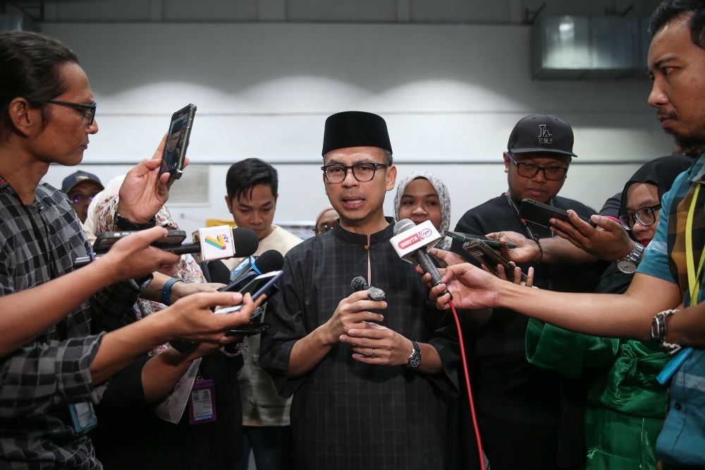 Communication Minister Datuk Fahmi Fadzil speaks to reporters during a Buka Puasa event at IWK Eco Park in Pantai Dalam, Kuala Lumpur, March 22, 2015. — Picture by Yusof Mat Isa