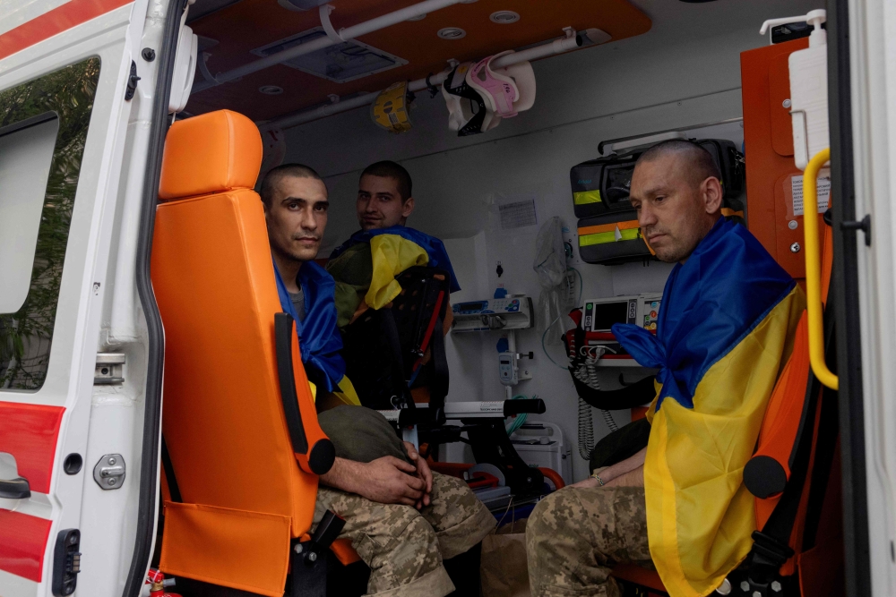 Freed Ukrainian prisoners sit in an ambulance upon their arrival after a prisoner exchange at an undisclosed location in Ukraine on April 19, 2025, amid the Russian invasion of Ukraine. — AFP pic