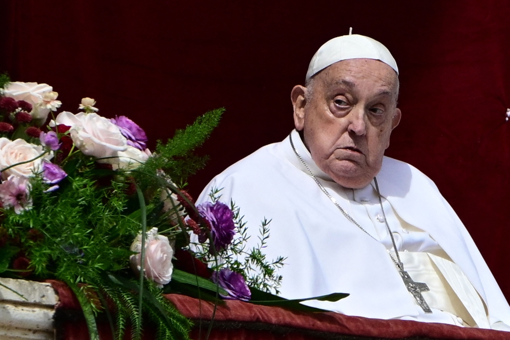 Pope Francis appears on the main balcony of St. Peter's basilica during the Urbi et Orbi message and blessing to the city and the world as part of Easter celebrations, at St Peter's square in the Vatican on April 20, 2025. — AFP pic