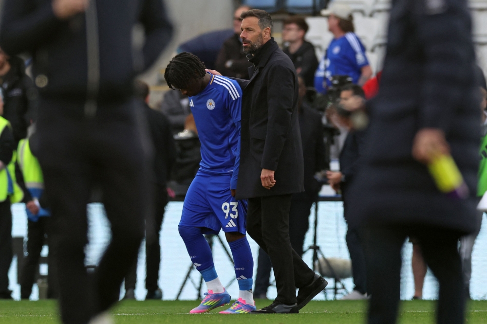 Leicester City's Dutch manager Ruud van Nistelrooy (R) consoles Leicester City's English midfielder #93 Jeremy Monga (left) on the pitch after the English Premier League football match between Leicester City and Liverpool at King Power Stadium in Leicester, central England on April 20, 2025. Leicester were relegated from the Premier League after a 1-0 defeat to Liverpool. — AFP pic