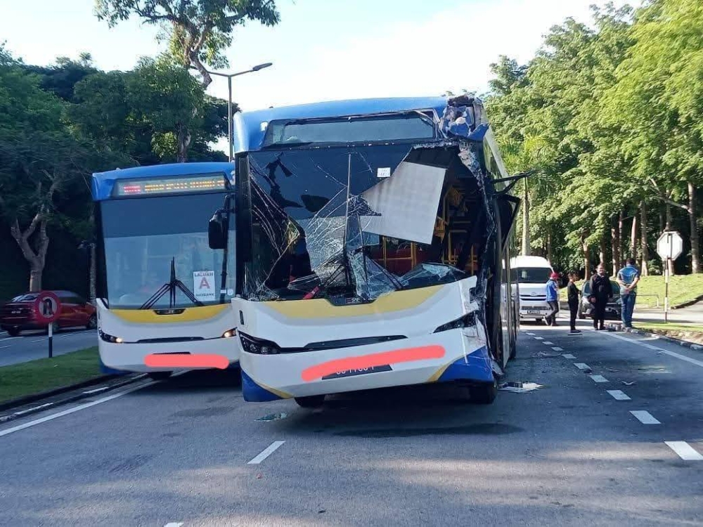 One of the two buses that were involved in the freak accident at a bus stop near Jalan Persiaran Perdana, UUM in Sintok, Kedah yesterday morning.