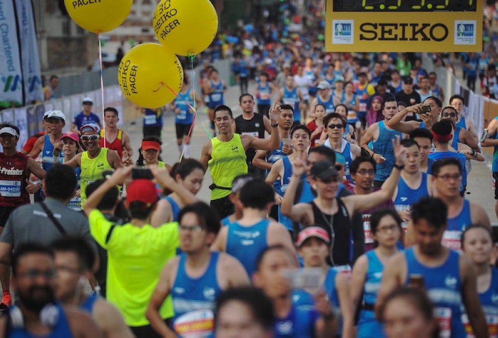 Participants celebrate reaching the finish line of the 2017 Standard Chartered KL Marathon in Kuala Lumpur May 21, 2017. — Bernama pic