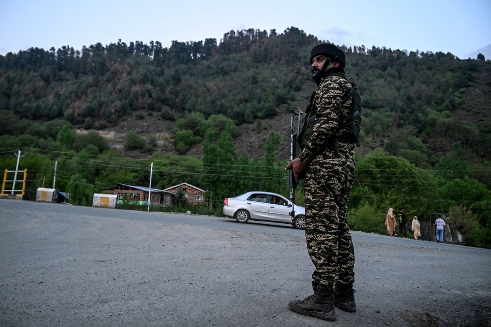 An Indian paramilitary personnel stands guard near Pahalgam, south of Srinagar, on April 22, 2025, following an attack. — AFP pic